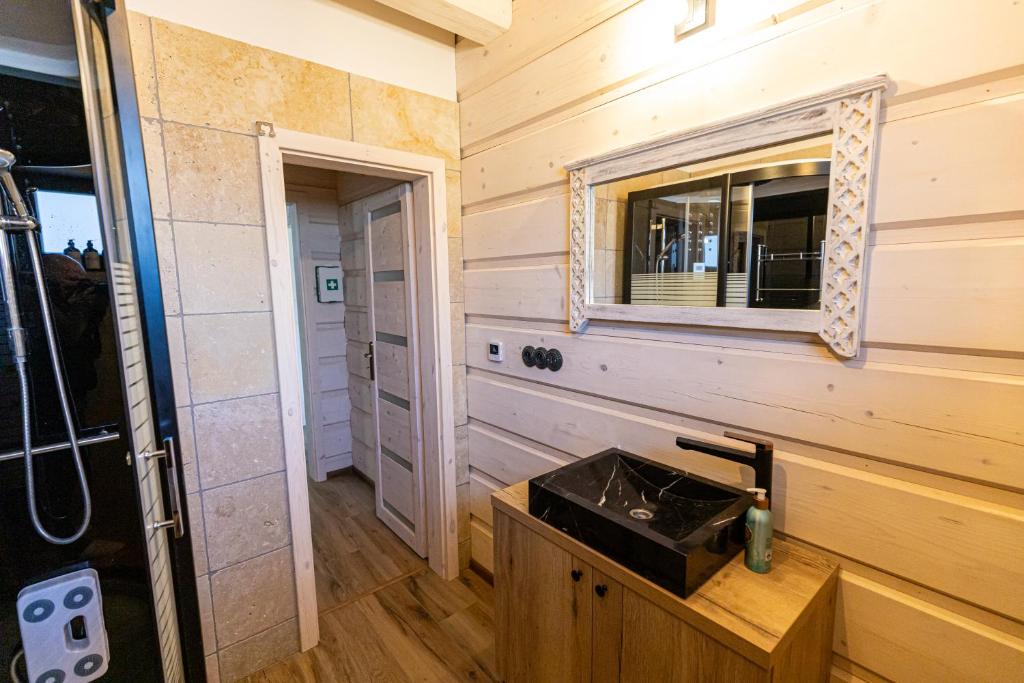 a bathroom with a sink and a mirror at Ozónia Wellnes House in Šahy