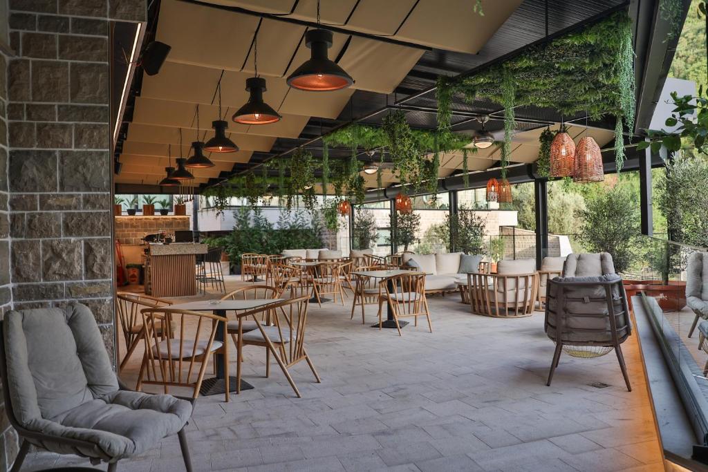 a patio with tables and chairs in a restaurant at Regent Resort Budva in Budva