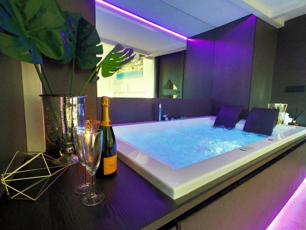 a large bath tub with a bottle of wine and glasses at LUX- Spanish Steps 60A Exclusive Suite Apartment in Rome