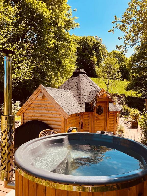 une niche en bois avec un grand bassin d'eau dans l'établissement Cabane, Kota Désiré, à Saint-Dié-des-Vosges