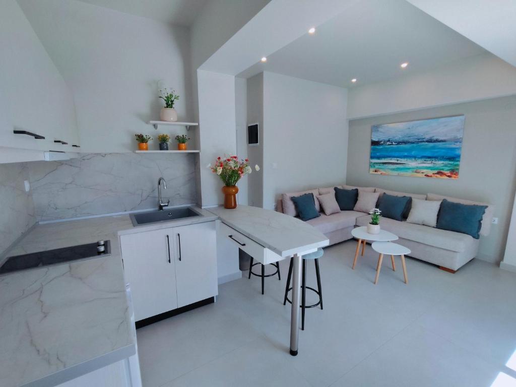 a kitchen and living room with a couch and a table at mesogios enjoyable living in Kallithea Halkidikis