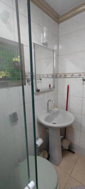 a bathroom with a sink and a mirror at Studio Centro Floripa 05 in Florianópolis