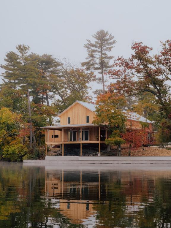 a house sitting on the side of a lake at Prospect Berkshires in North Egremont