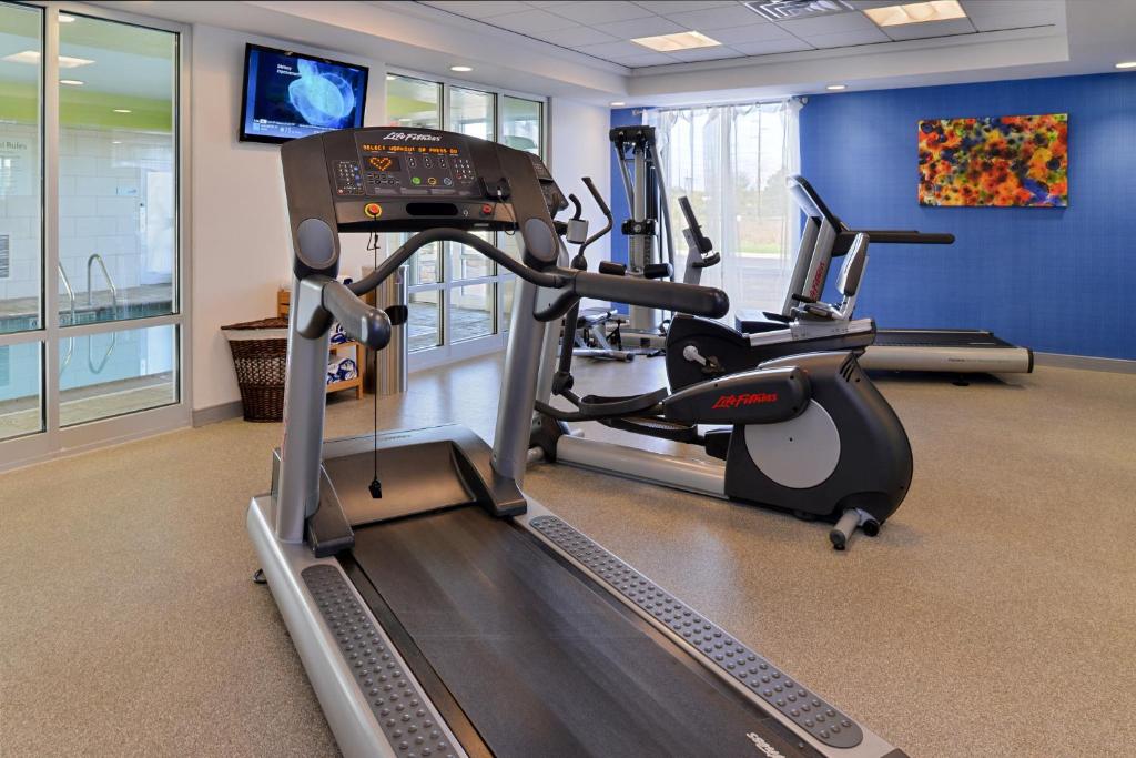a gym with a treadmill and a elliptical machine at Holiday Inn Express & Suites Terre Haute by IHG in Terre Haute