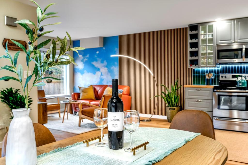 シアトルにあるEmerald Sahalee - Capitol Hill -3 bedrooms with free parkingのワイングラス2杯付きのテーブルに座ったワイン1本