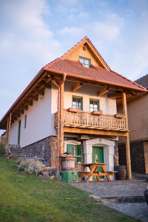 a house with a deck on the side of it at Vinařská búda nad golfem in Skalica