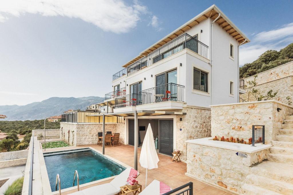 a villa with a swimming pool and a house at Villa Pietroza in Kaş