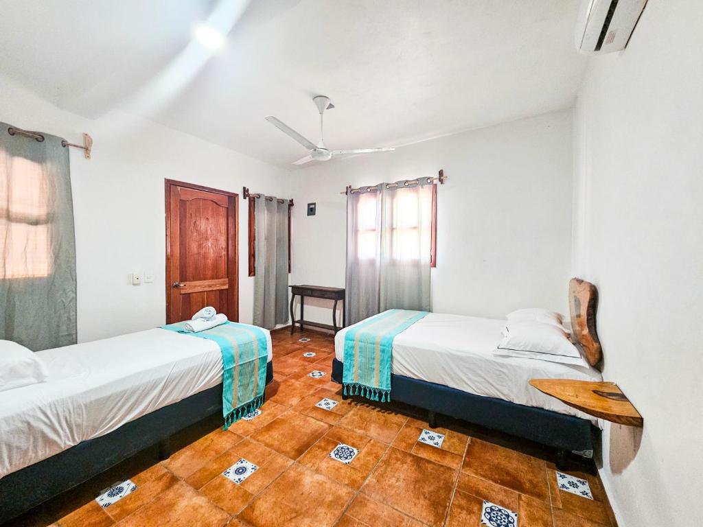 Postel nebo postele na pokoji v ubytování Hotel MB Bacalar