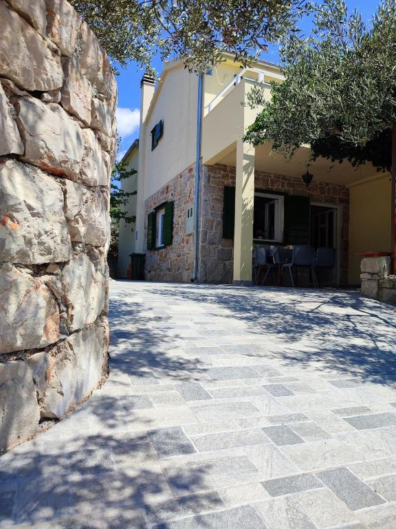 a stone walkway in front of a building at Peacefull getaway island Hvar! in Selca kod Starigrada