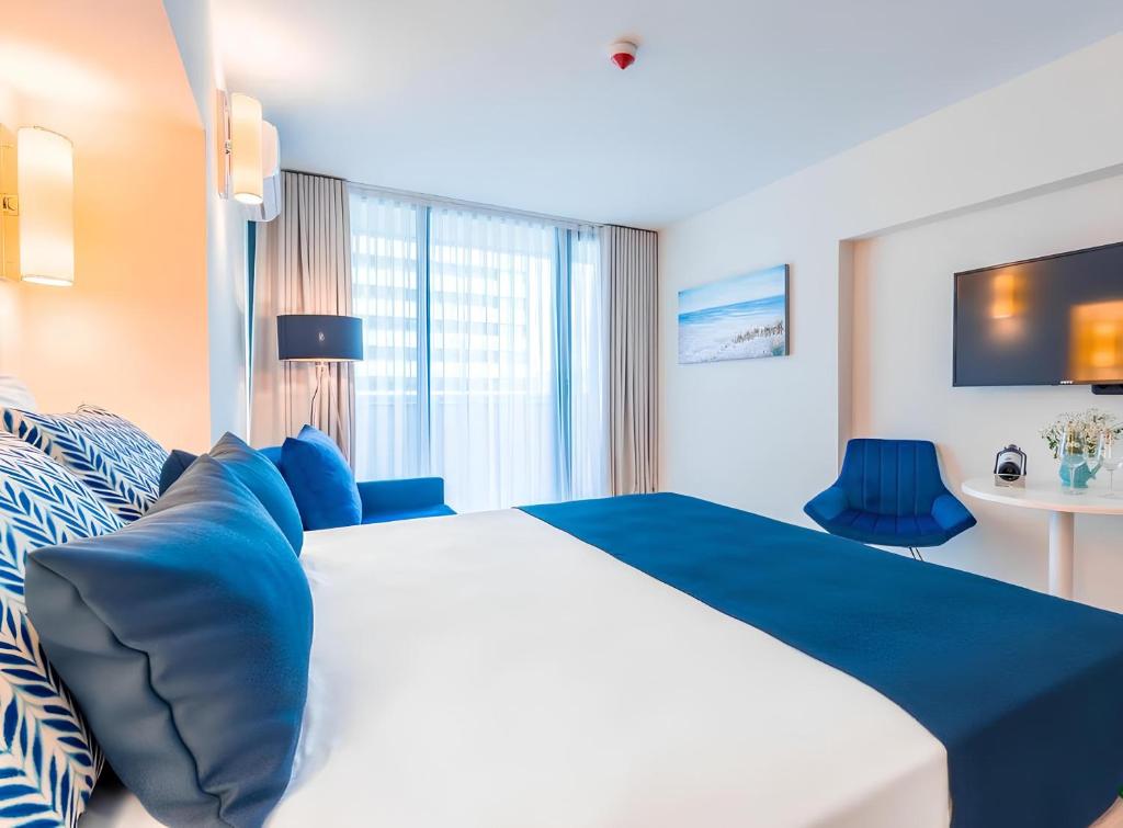Postel nebo postele na pokoji v ubytování New Orbi City Suite