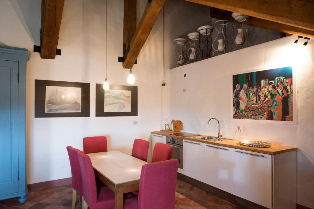 a kitchen with a table and chairs and a sink at Castello di Rocca Grimalda in Rocca Grimalda