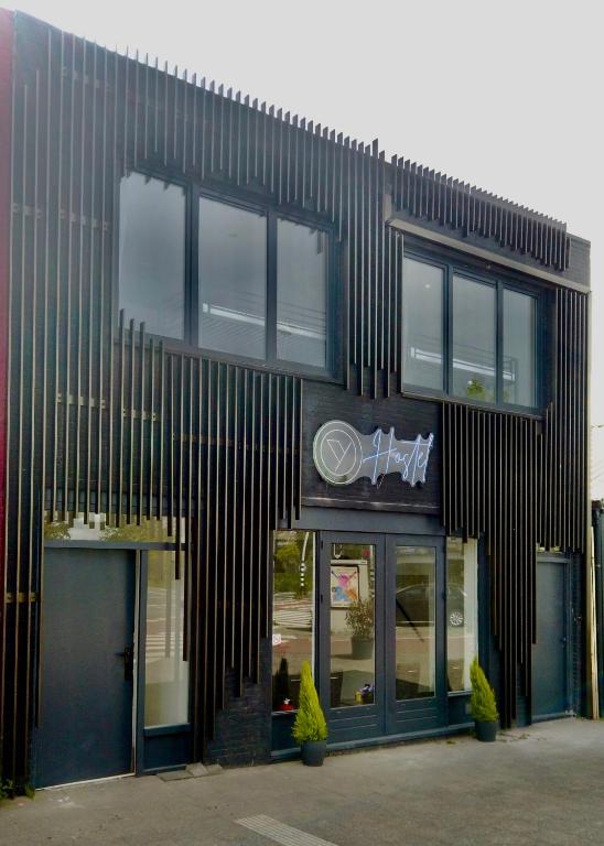 a black building with windows on the side of it at Y Hostel in Amsterdam