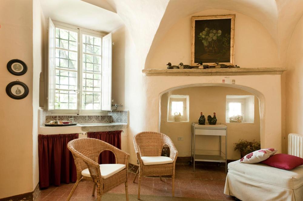 a living room with a couch and chairs and a table at Castello di Rocca Grimalda in Rocca Grimalda
