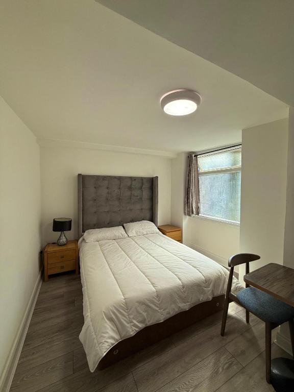 a bedroom with a large bed and a window at Pera2025 in Feevaghmore