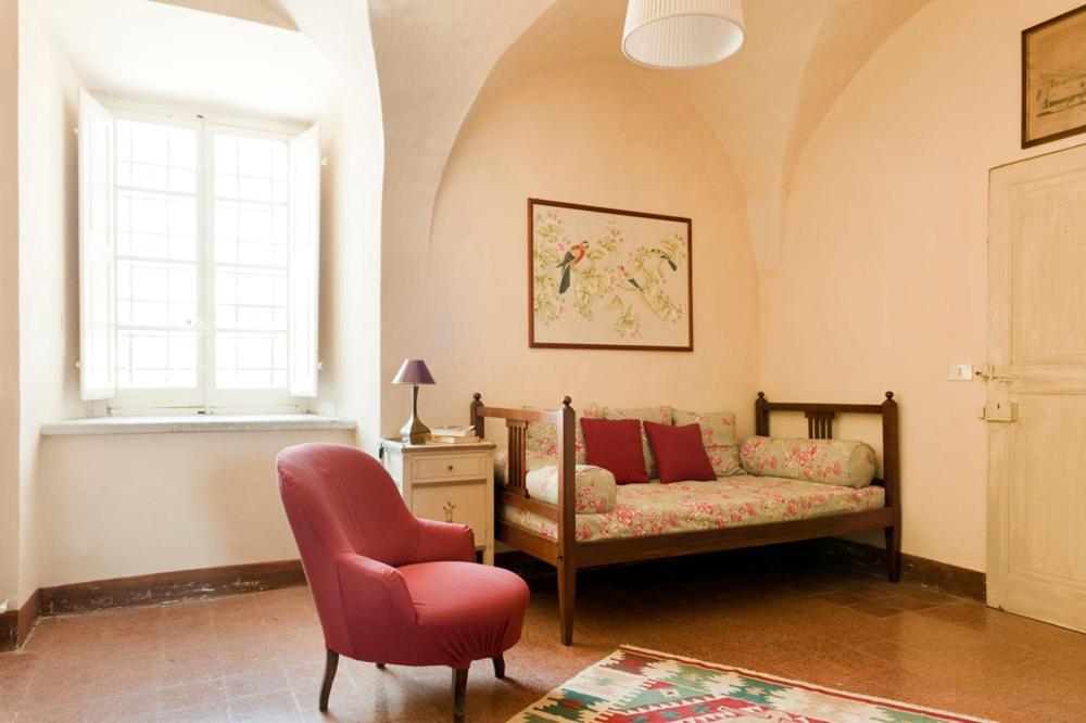 a living room with a couch and a chair at Castello di Rocca Grimalda in Rocca Grimalda