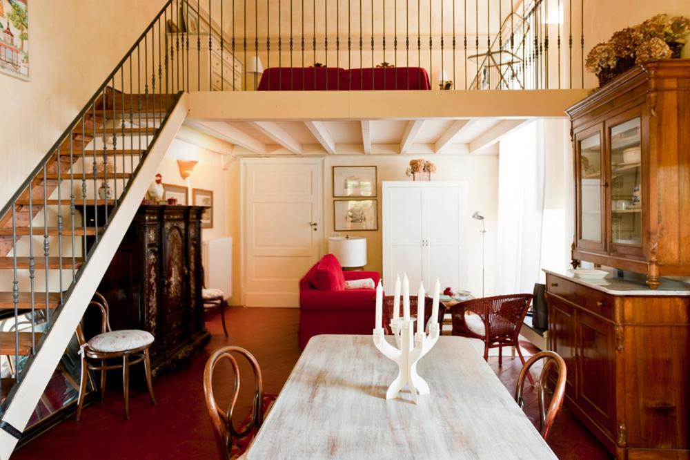 a living room with a table and a loft at Castello di Rocca Grimalda in Rocca Grimalda
