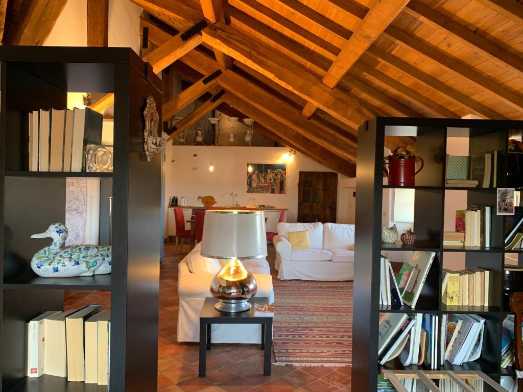 a living room with a couch and a table with a lamp at Castello di Rocca Grimalda in Rocca Grimalda