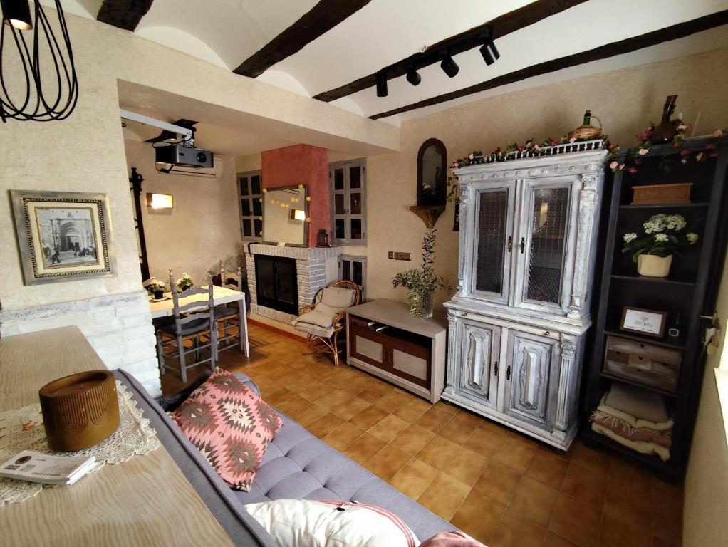 a living room with a couch and a table at Casa de piedra recién reformada LUNA ROSA in Biar