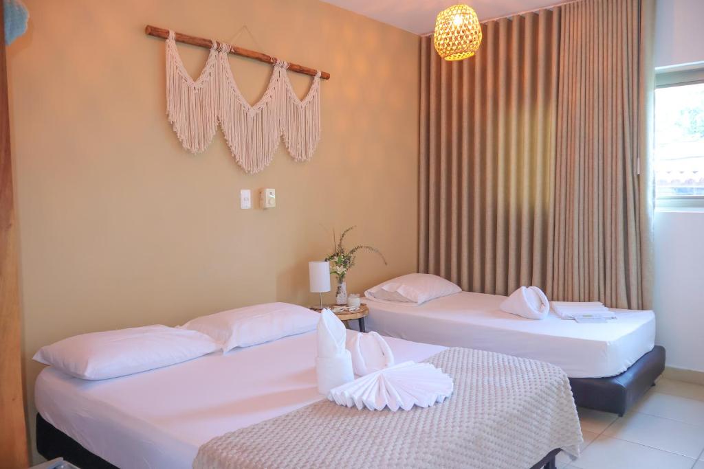 Voodi või voodid majutusasutuse Awa De Mar Hotel Tolu toas