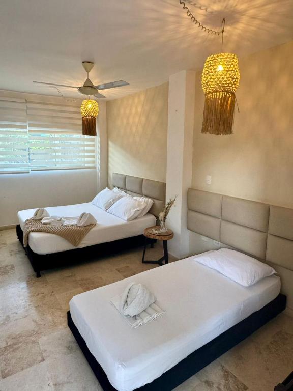 Voodi või voodid majutusasutuse Awa De Mar Hotel Tolu toas
