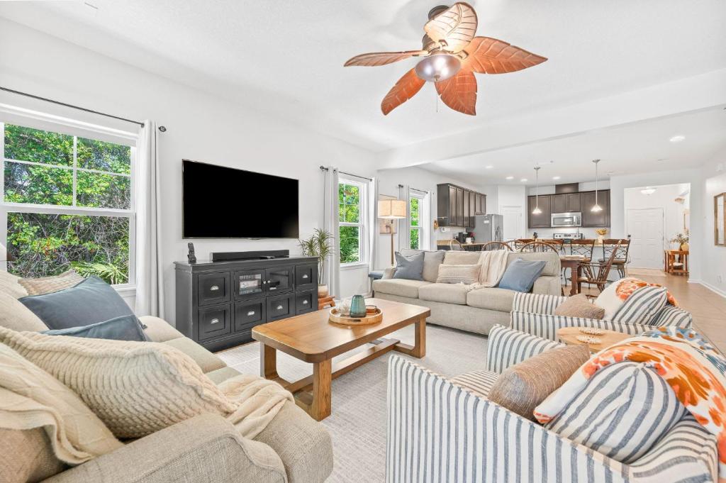 a living room with couches and a ceiling fan at Dog-Friendly 4BR Coastal Getaway Close to Beach in Saint Augustine