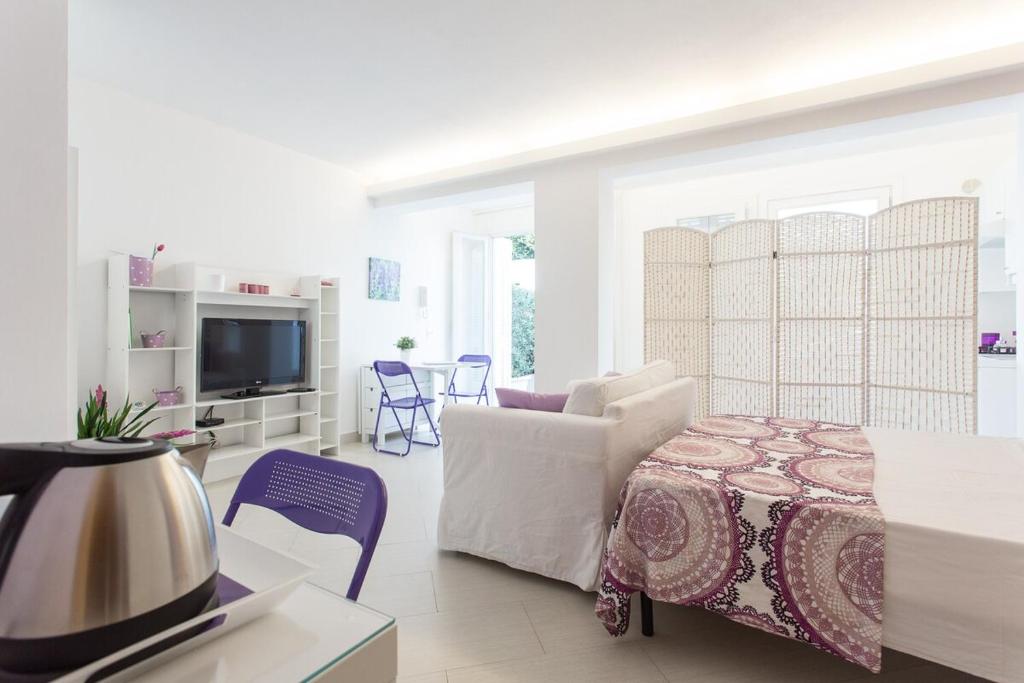A bed or beds in a room at Mondello Suites FLH - Gorgonia