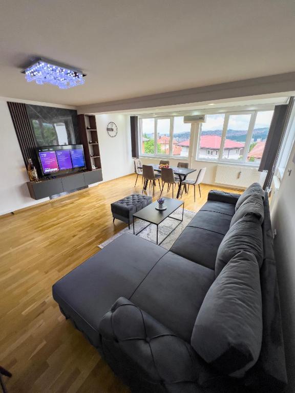 a living room with a large couch and a table at City View Apartment in Sarajevo