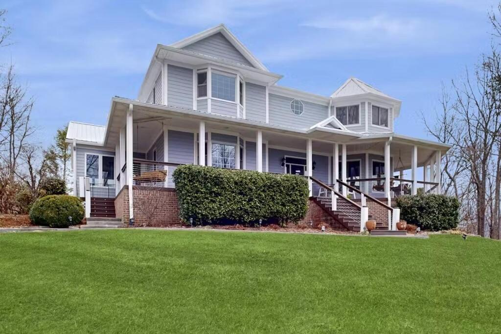 a white house with a lawn in front of it at Wethero Ridge Moutain Estate & Hot tub in Hendersonville