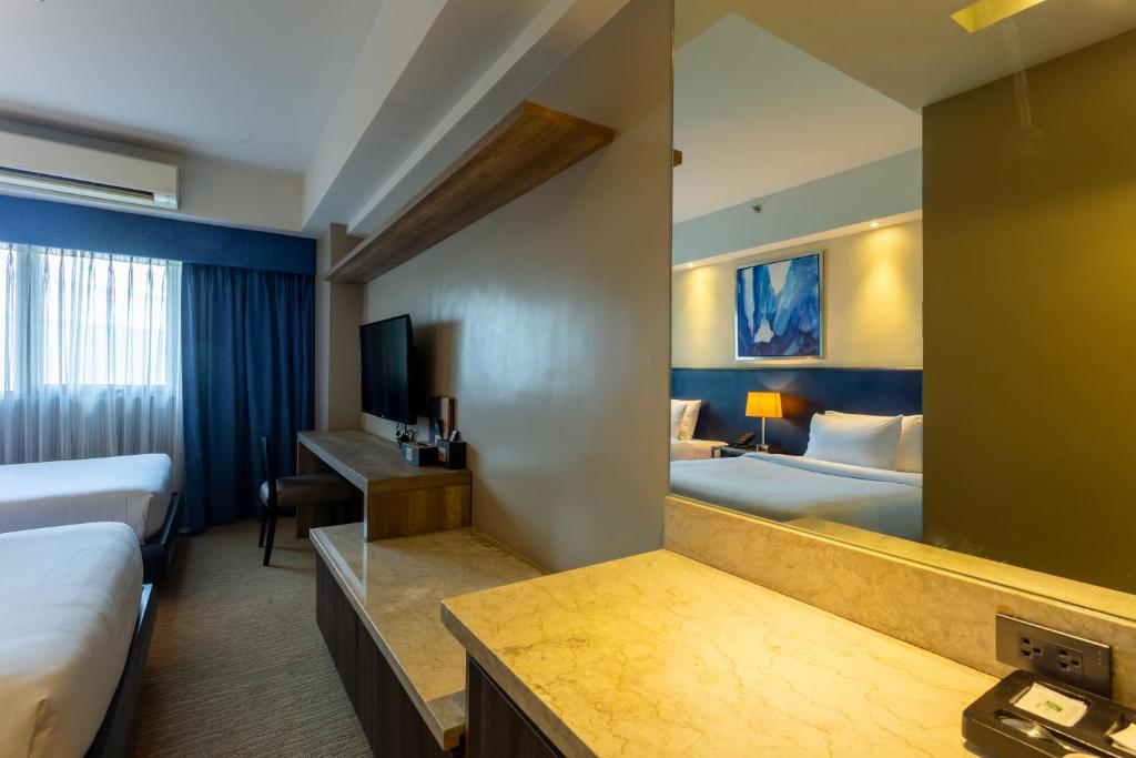 Postel nebo postele na pokoji v ubytování Santorini Hotel