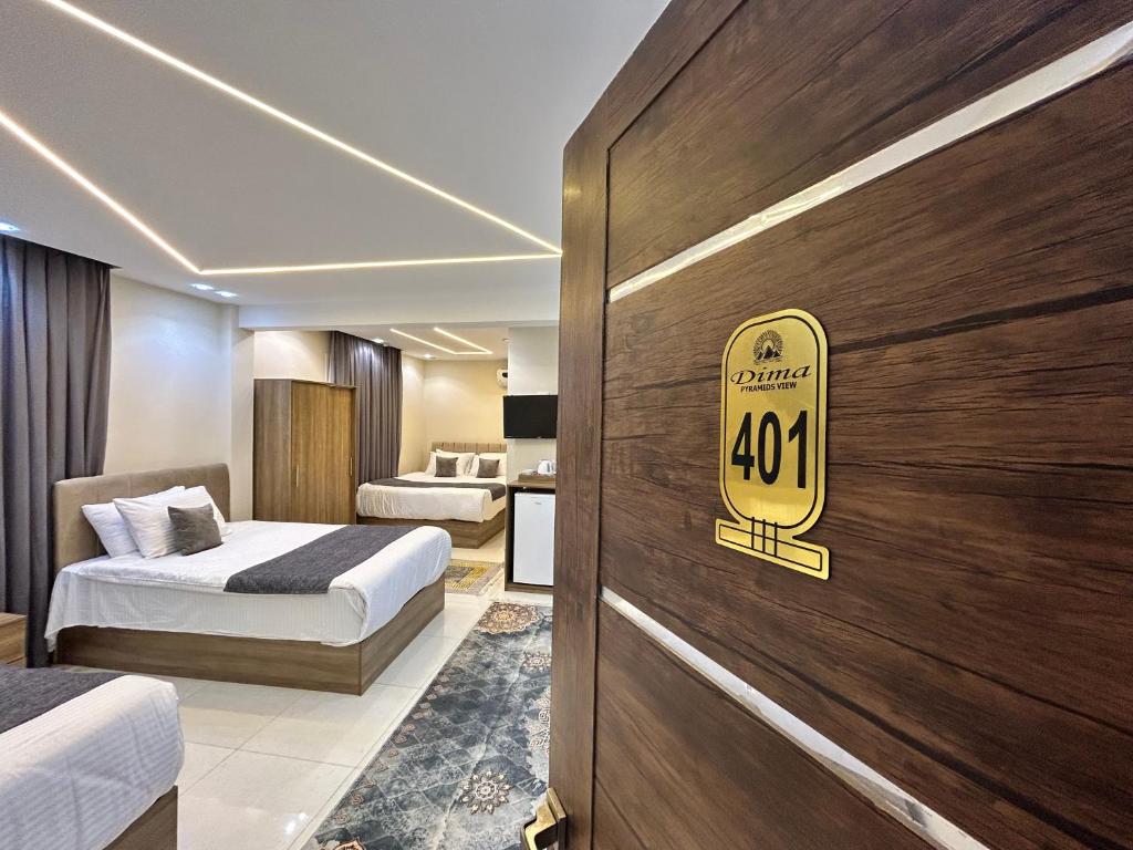 a hotel room with two beds and a sign on the door at Dima Pyramids View in Cairo