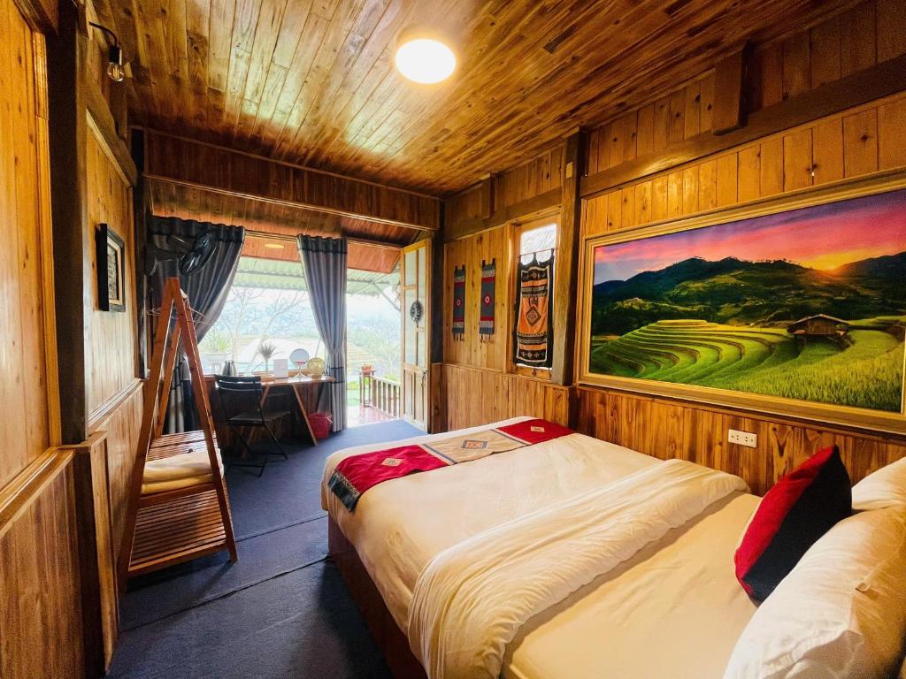 a bedroom with a bed and a painting on the wall at Sapa Eco Hugo in Sapa
