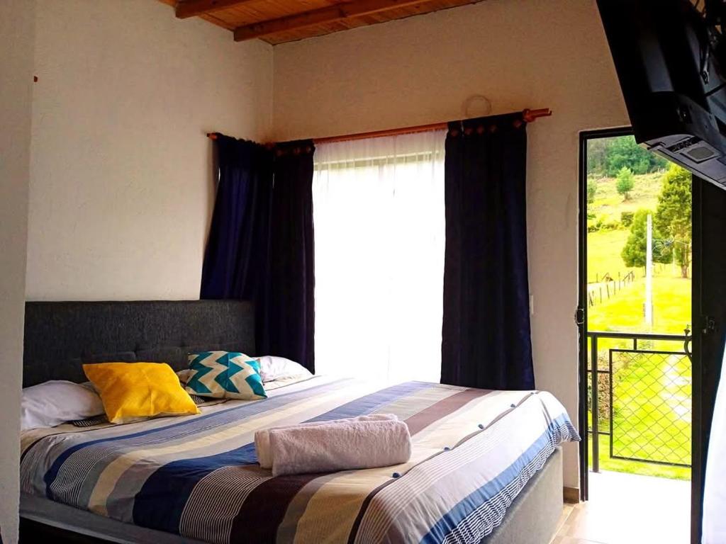 En eller flere senge i et værelse på Habitaciones campestres 202