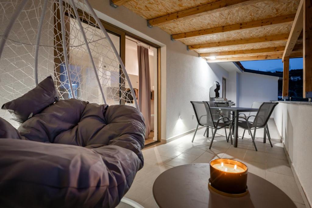 a living room with a couch and a table at Grgurić Apartments in Rab