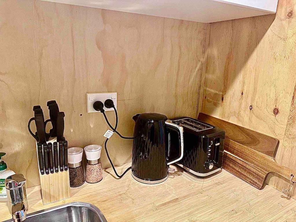 a kitchen counter with a toaster on a counter top at Self-contained Tiny Sleepout in Hamner in Hanmer Springs