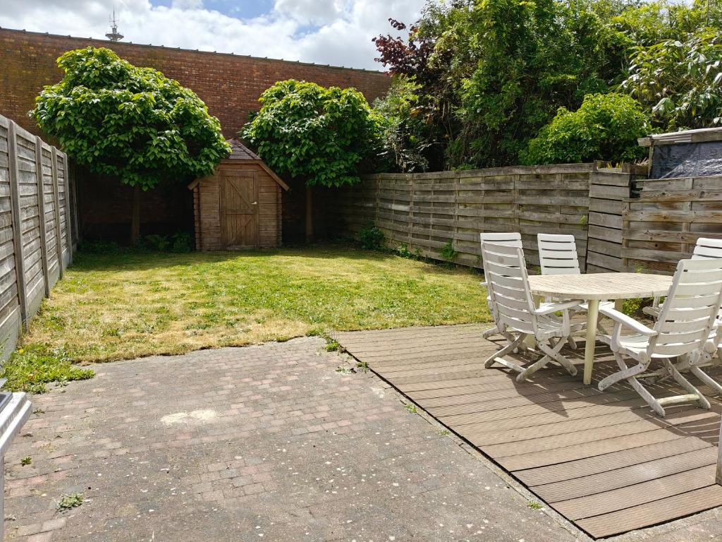 a patio with a table and chairs in a yard at House with garden in Turnhout