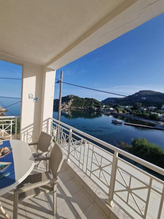 a balcony with a view of the water at Emporios Mansion in Emporeiós