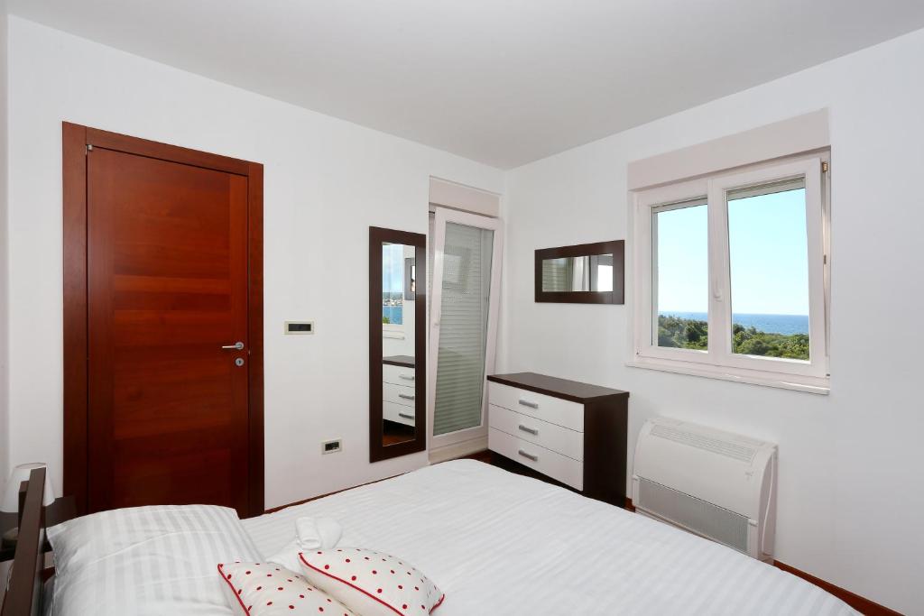 Posteľ alebo postele v izbe v ubytovaní Apartment Puntamika
