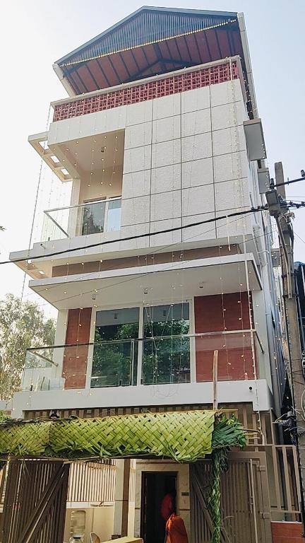 a man standing in front of a tall building at Chandra in Bengaluru