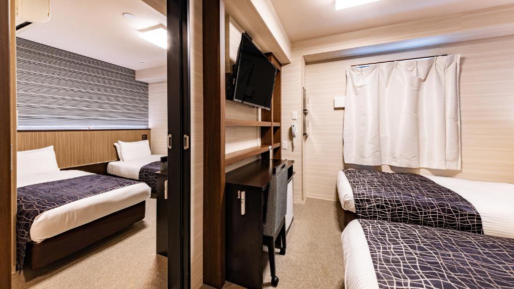 Postel nebo postele na pokoji v ubytování APA Hotel Nambaminami Daikokucho Ekimae