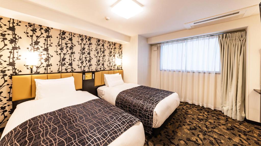 Postel nebo postele na pokoji v ubytování APA Hotel Nambaminami Daikokucho Ekimae