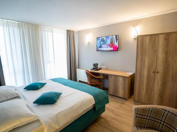 Postel nebo postele na pokoji v ubytování Hotel Perla