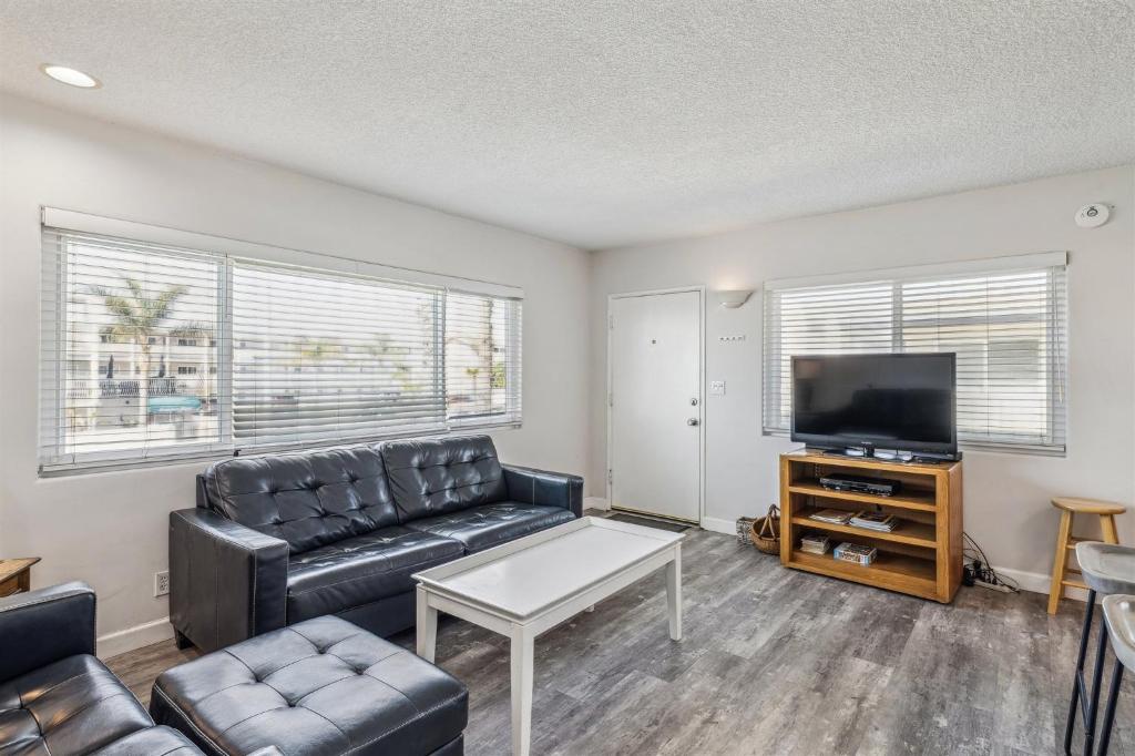 a living room with a couch and a flat screen tv at Beautiful 2 Bed Beach Condo #201 in Carpinteria