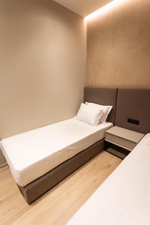 Postel nebo postele na pokoji v ubytování South Inn Hotel