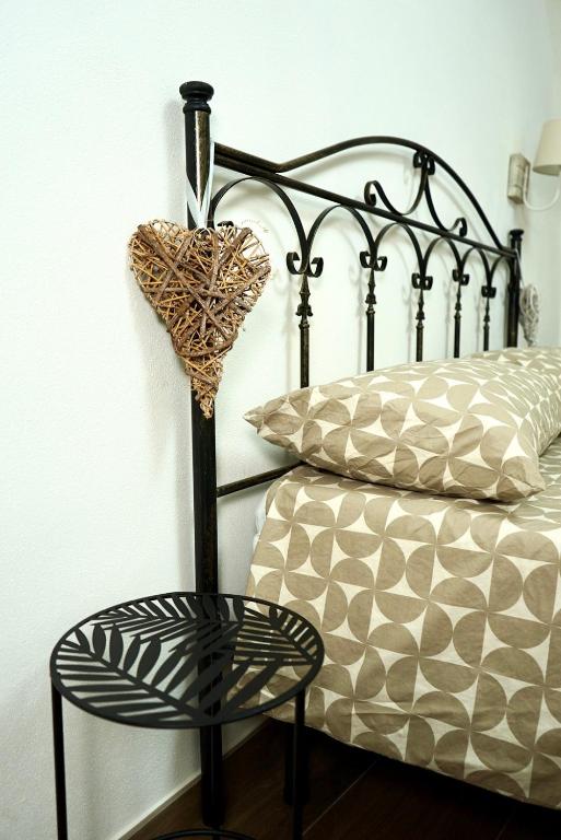 a bedroom with a bed with a chair next to it at B&B del Gatta in San Severo