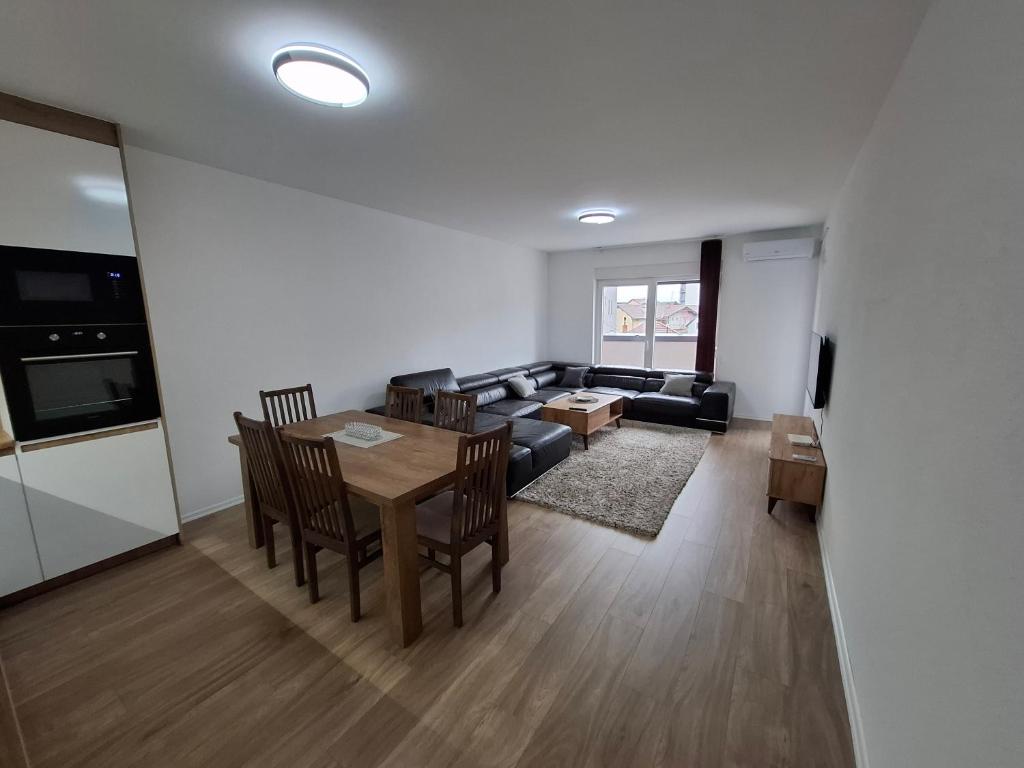 a living room with a table and a couch at Comfort Apartment 3 in Ferizaj