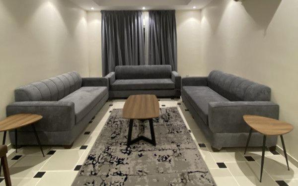 a living room with two couches and a table at قاردن وحدات سكنية خاصة in Al Madinah
