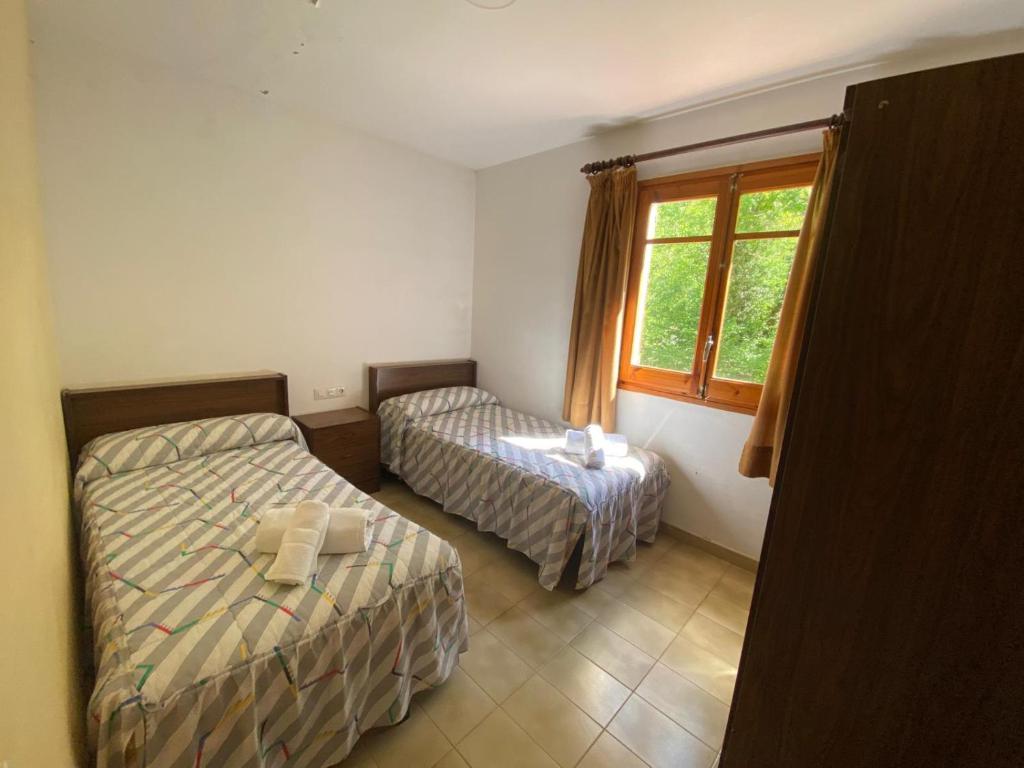 Postel nebo postele na pokoji v ubytování hotel vall fosca