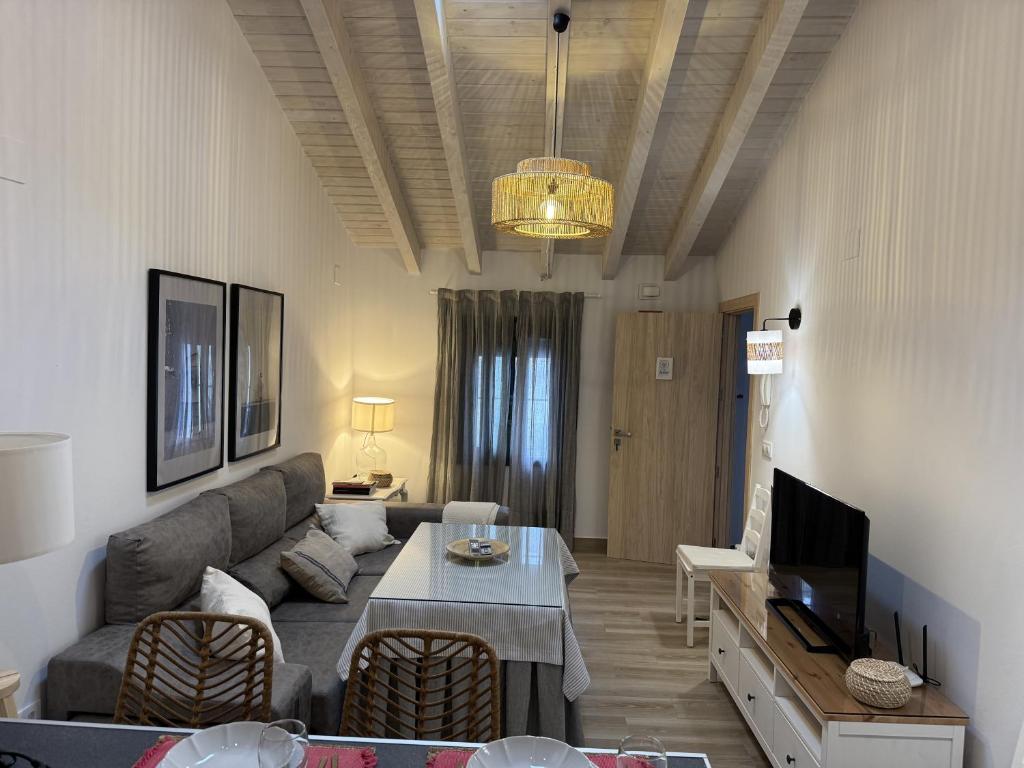 a living room with a couch and a table at Apartamentos La Gruta de Aracena 3 in Aracena