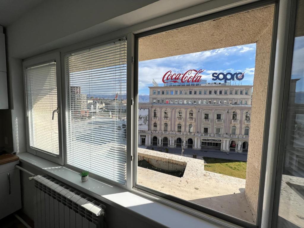 a window with a view of a large building at Cozy Corner at Main Square in Skopje