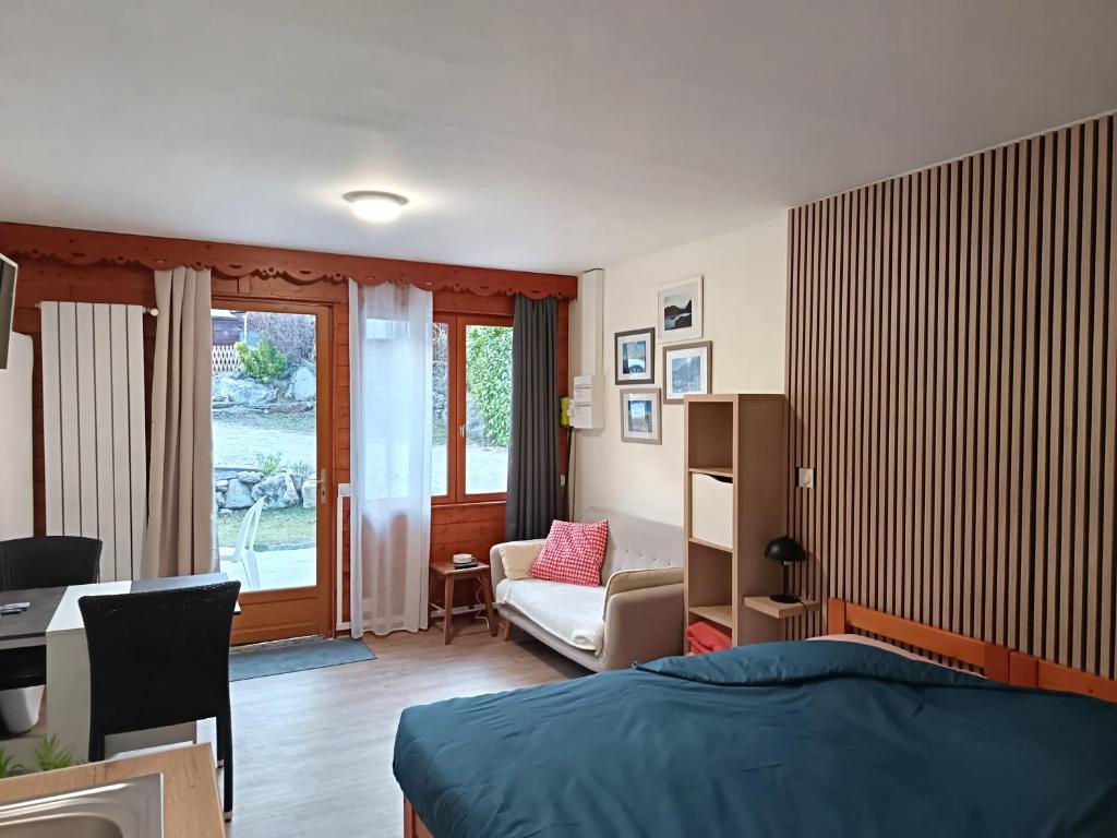 a bedroom with a bed and a desk and a chair at Les Chalets d'Arlos in Arlos